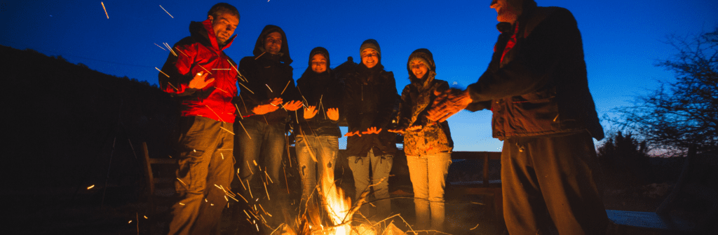 group of people around a campfire