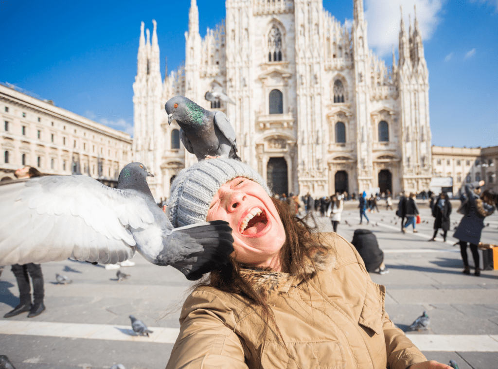 woman getting attacked by two pigeons