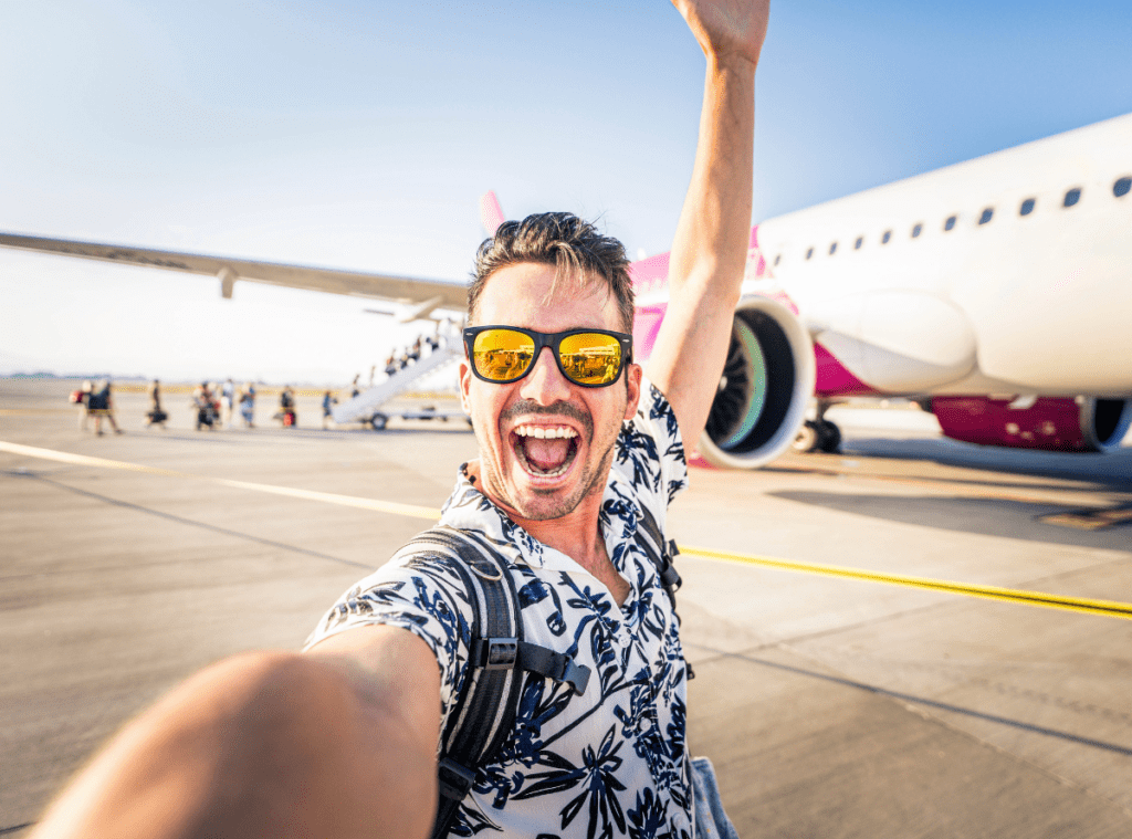 man in front of a plane smiling