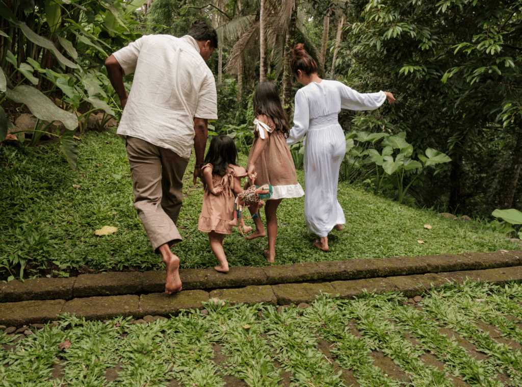 family hopping over a log