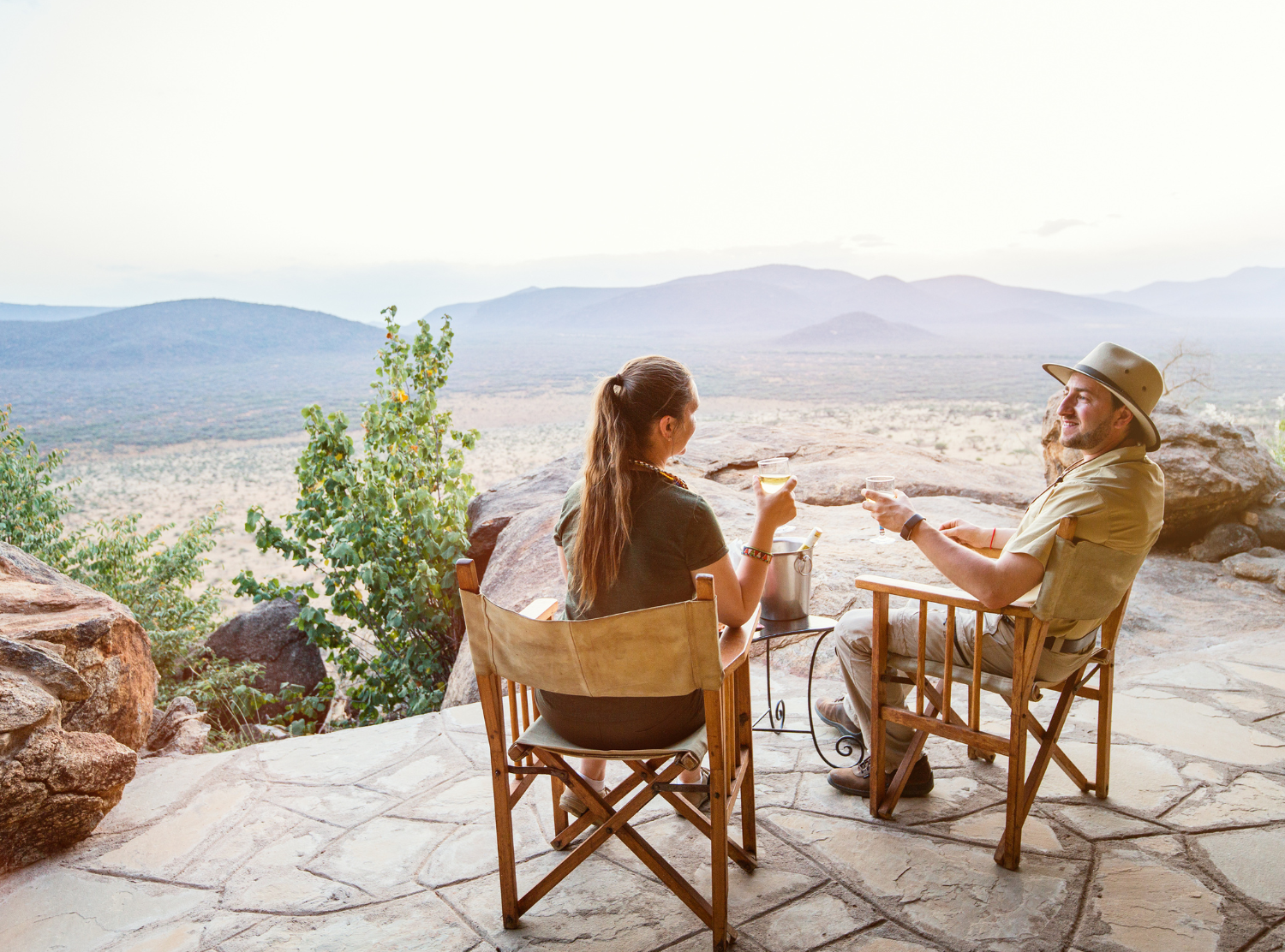 two ladies toasting overlooking a mountain