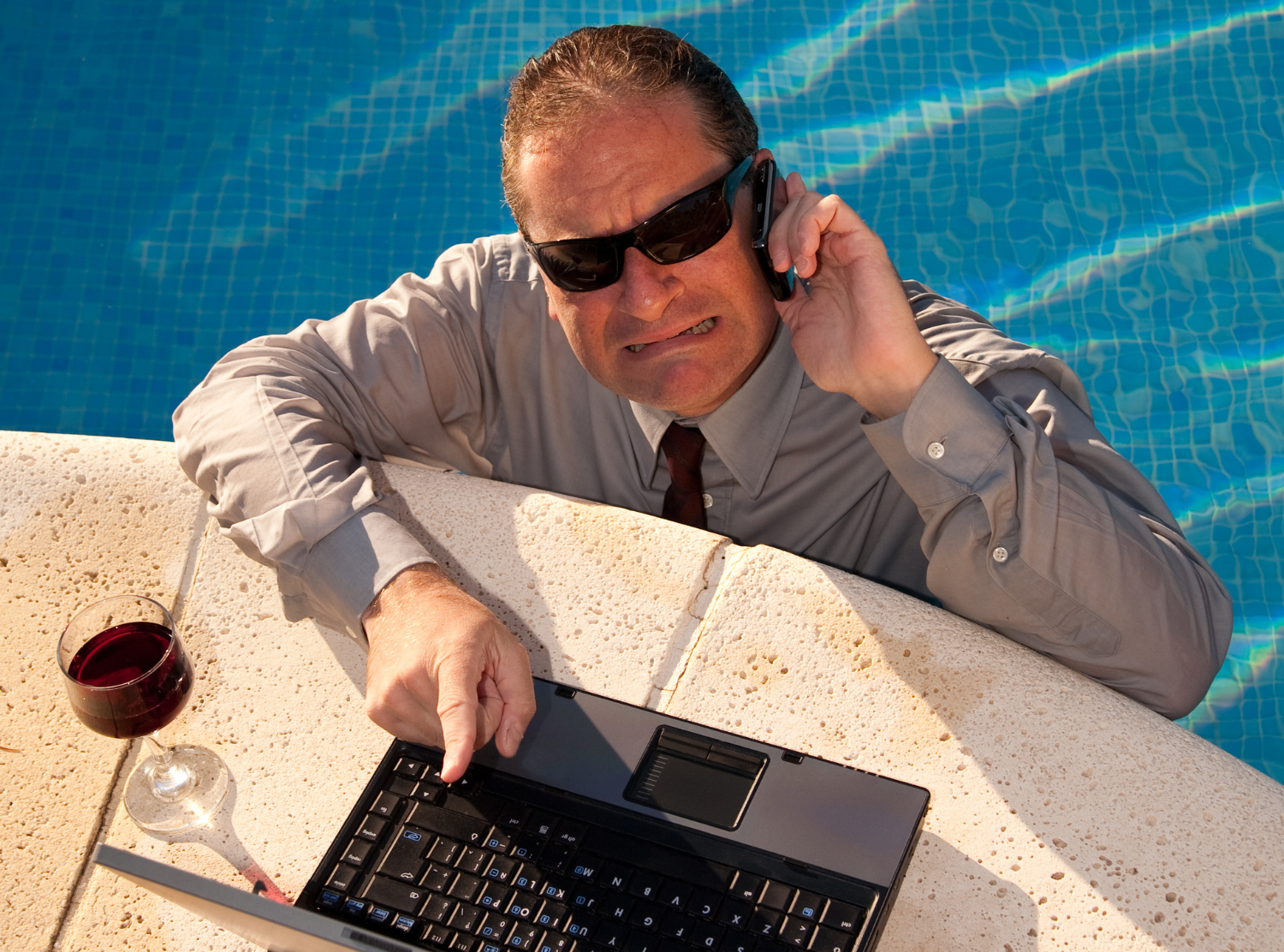 stressed man on phone in a pool