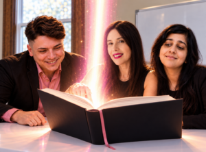 Von Mack Agency team opening a logbook with a bright pink beam of light in their office.